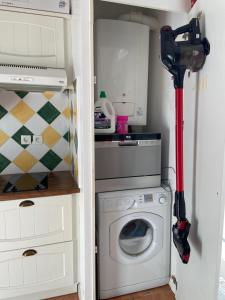 a laundry room with a washing machine and a washer at Appartement Le Rochettois - VALGELON LA ROCHETTE - 25 mn station de ski Collet d'Allevard in La Rochette +3 photos