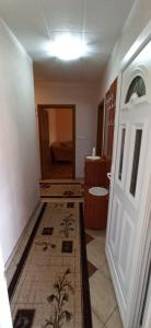a bathroom with a door and a tile floor at Vila Nikola & Aleksa in Vrnjačka Banja