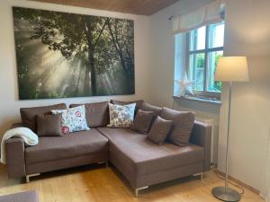 a living room with a couch and a large painting at Ferienhaus Waldhaus in Grafenau