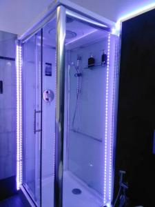 a bathroom with a shower with lights in it at Palazzo Iargia in Canicattini Bagni