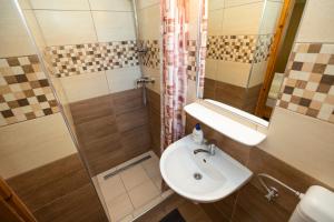 a bathroom with a sink and a shower at Cecey Apartman in Eger