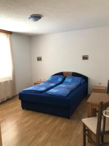 een slaapkamer met een blauw bed in een kamer bij House Skoko in Sarajevo