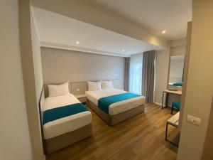 Postel nebo postele na pokoji v ubytování Hotel Rhodos