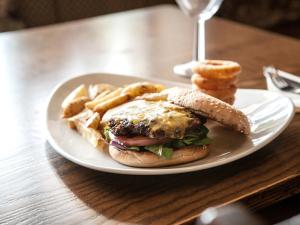 a plate with a sandwich and french fries on a table at The Crewe Arms Hotel in Crewe