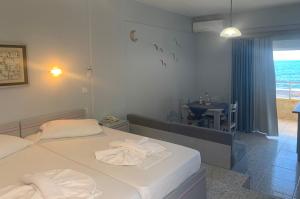 a hotel room with two beds with towels on them at Ermis Suites in Platanias