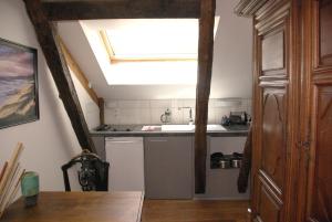 a kitchen with a sink and a skylight at Péchalvet in Fleurac