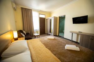 Ένα ή περισσότερα κρεβάτια σε δωμάτιο στο Hotel Chveni Ezo