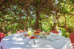 a table with food and a bowl of fruit on it at Apartment Rubina with secure parking in Medulin