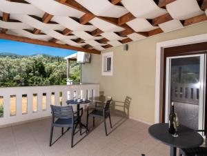 a dining room with a table and chairs on a balcony at Aurora Studios in Nikiana