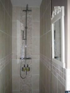 a bathroom with a shower with a glass door at Ladderstile Retreat in Congleton