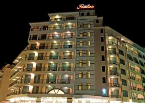 a building with a neon sign on top of it at Karolina Hotel in Sunny Beach