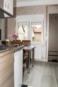a kitchen with a table and a window at CITY APARTMENT BB in Bajina Bašta