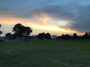 a green field with a sunset in the background at New bedroom queen size bed at Las Vegas for rent-2 in Las Vegas