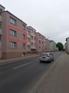 a car parked on a street next to a building at Apartament 26 in Drawsko Pomorskie