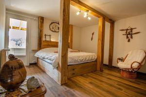 a bedroom with a bed and a mirror in it at Gîte du Mont Plaisir in Chouvigny