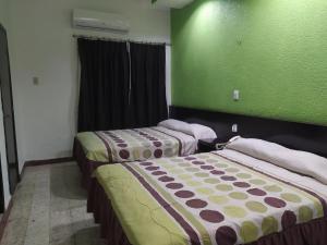 Una cama o camas en una habitación de Hotel y Restaurante Ritz de Tabasco