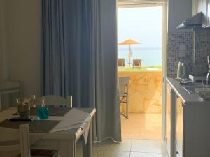 a kitchen with a table and a view of the ocean at Ermis Suites in Platanias