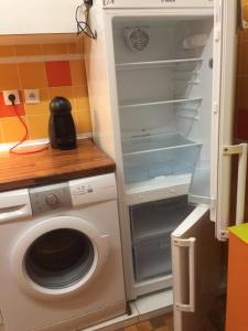 a kitchen with a washing machine and a washer at St Yves in Rennes