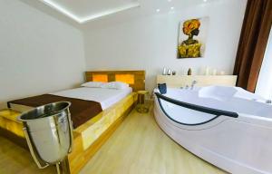 a bedroom with a bed and a bath tub at Onyx Luxury in Ulcinj +79 photos