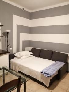 een slaapkamer met een bed en een glazen tafel bij Casa Vincenzo in Bologna