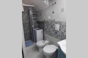 a small bathroom with a toilet and a shower at il colibri' in Procida