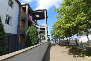 a building with balconies on the side of a sidewalk at Hill & Sea House in Ribeira Grande