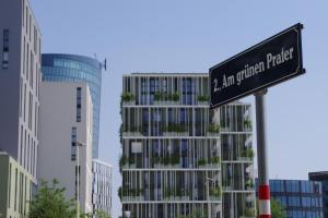 a street sign in front of a tall building at easy flat Green Prater in Vienna