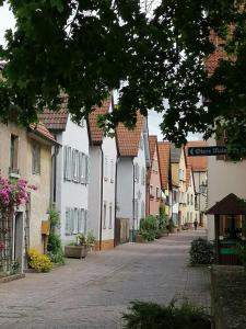 an empty street in a town with white houses at Ferienwohnung Dillamar in Veitshöchheim