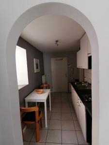 a kitchen with a table and a white table and chairs at Ferienwohnung Dillamar in Veitshöchheim +12 photos