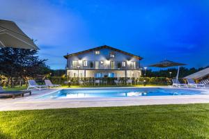 a house with a swimming pool in front of a house at Suite romantic in Capranica