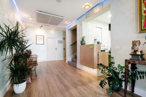 an empty room with potted plants in an office at H Boutique la Caleta bay in La Herradura