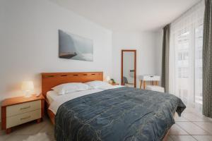 a bedroom with a large bed and a window at Skiper resort Savudrija in Savudrija