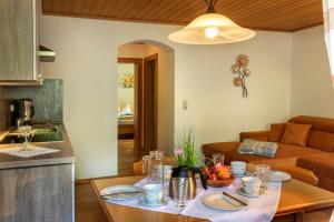 a kitchen and a living room with a table with food at Bauernhof Klausbauer in Grossarl +55 photos