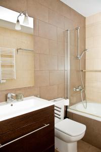 a bathroom with a sink toilet and a shower at Claris Apartments in Barcelona