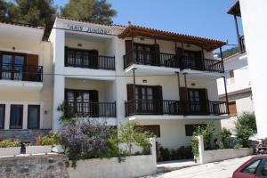 a white building with balconies on the side of it at Aris Junior Studios Neo Klima Skopelos in Neo Klima