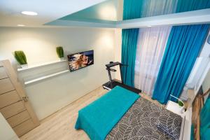 a gym room with a treadmill and blue curtains at Jacuzzi Sauna Luxury Spa Apartment in Kyiv
