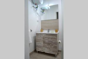 a bathroom with a sink and a mirror at Comfy Box Las Canteras in Las Palmas de Gran Canaria +16 photos