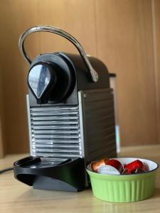 a toaster next to a bowl of fruit on a table at Trionfo your home in Trieste business and holiday stays in Trieste