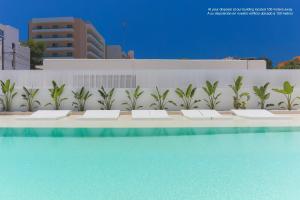 a large pool of water with plants in it at Sunrise Suites in Ibiza Town