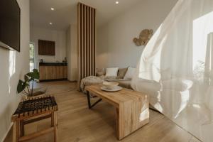 a living room with a couch and a table at Casa Costa Suites in Kanali