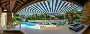 a swimming pool in a house with a large ceiling at Résidence La Ménado in Cavalaire-sur-Mer