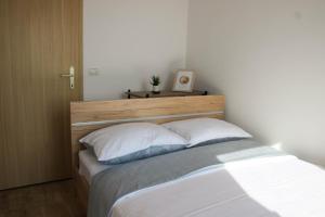a bedroom with a bed with two pillows at Bellevue in Marezige