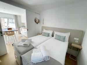 sypialnia z dwoma łóżkami i ręcznikami na nich w obiekcie Oasis Beach Apartment w Corralejo