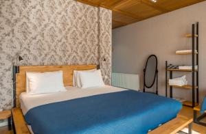 A bed or beds in a room at Vache Hotel