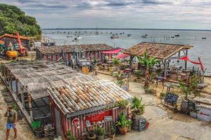 an aerial view of a village with boats in the water at Colibri Appart' T2 au coeur du Bassin d'Arcachon in Gujan-Mestras