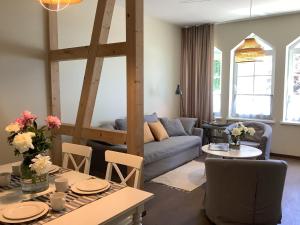 a living room with a couch and a table at Vila MAY in Juodkrantė