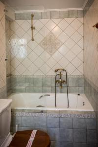 a bath tub with a faucet in a bathroom at Acronafplia Pension A in Nafplio