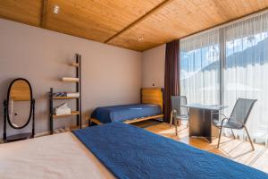 A bed or beds in a room at Vache Hotel