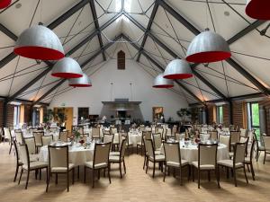 a large banquet hall with tables and chairs and chandeliers at Schloss Hohenkammer in Hohenkammer