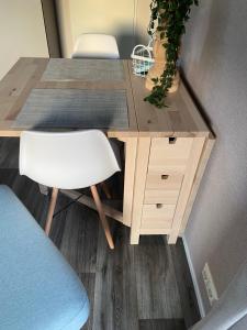 a wooden desk with a white chair and a table at Lieblingsplatz Koblenz in Koblenz